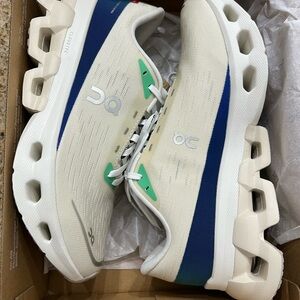 On Running Cream and Blue Athletic Shoes